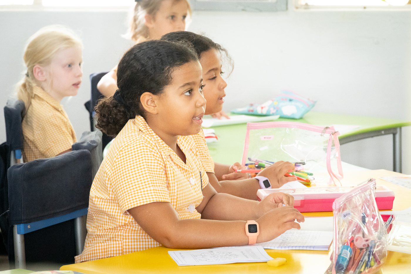 Pupils concentrating on their work at a classroom table